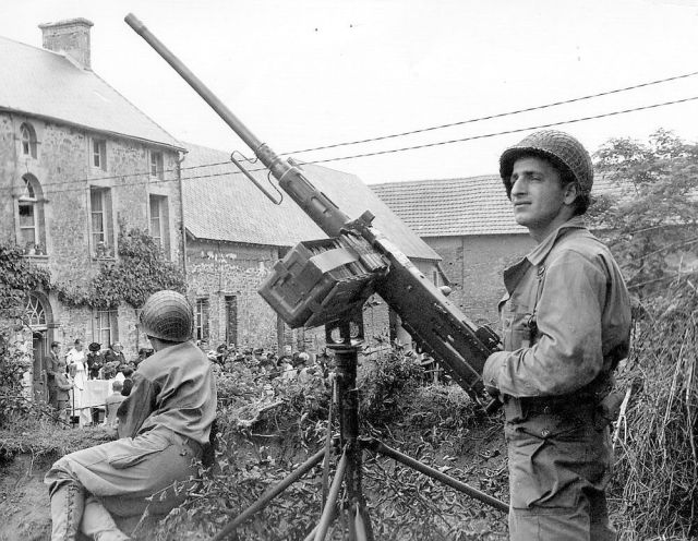 Military soldiers stand guard in the foreground while spiritual soldiers do battle in the background.